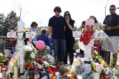 Christian Bale and his wife visit the memorial in Aurora, Colorado.