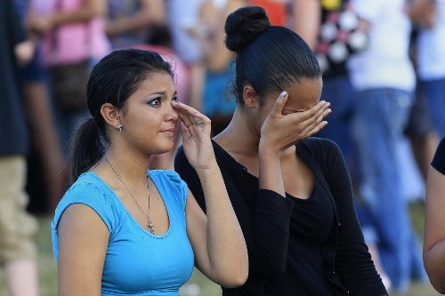 Tears bring healing in such sadness. Two women at one of the many candlelight vigils.