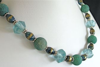 Recycled glass in a magnificent blue combined with crackle Agate & an interesting oval shaped Czech glass bead. Necklace closes with a pewter hook & eye at 18 inches.